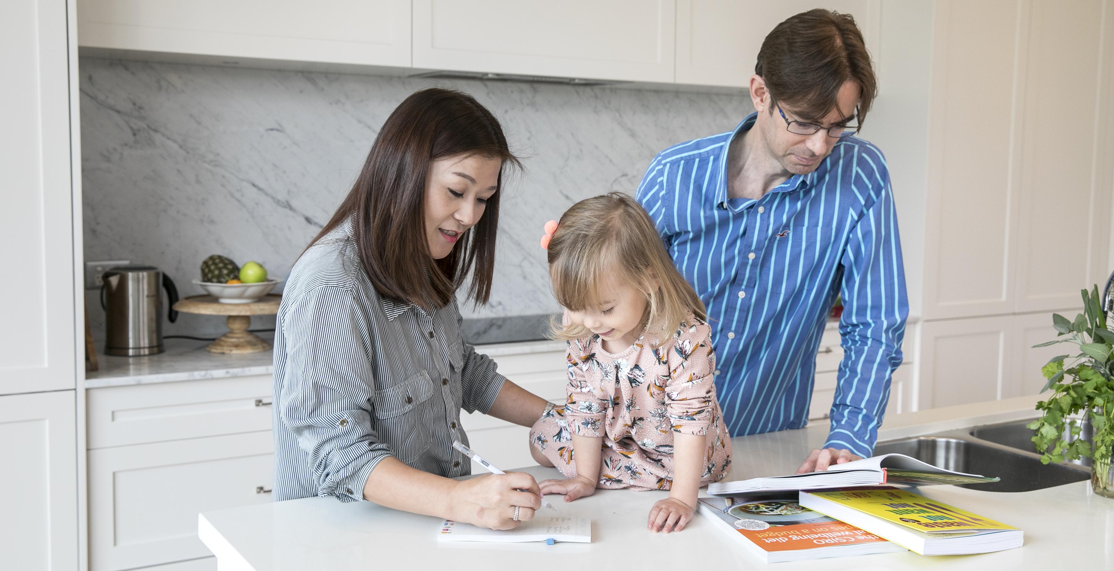 Family with child writing a meal plan