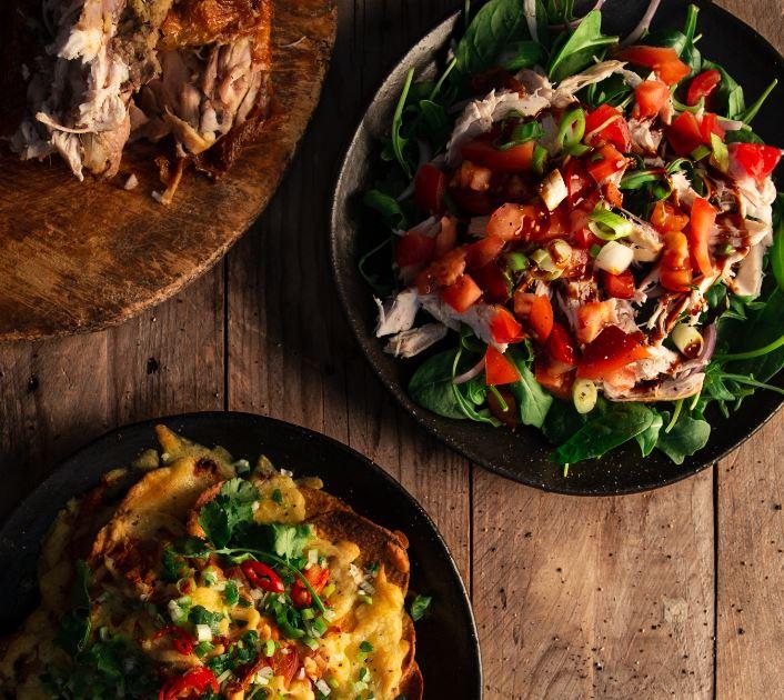 Image of a BBQ chicken, nachos and chicken salad
