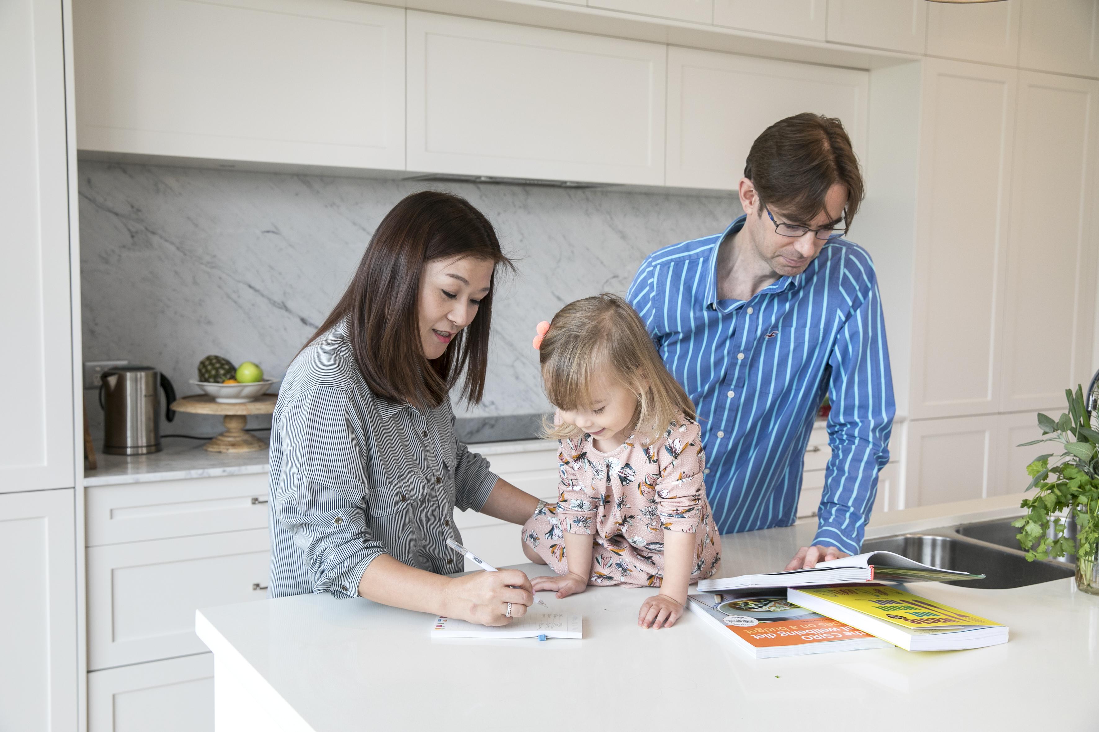 Family with child writing a meal plan