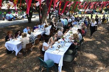 Image of people eating at a table outside